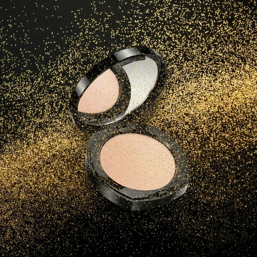 Cosmetics creative - a pressed-powder compact in a rain of gold